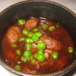 Chicken oysters, "coq au vin" style, with bacon and peas