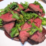 Grilled beef hangar steak with fingerling potatoes, king trumpet mushrooms, asparagus, black olives and arugula
