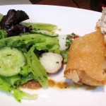 Applewood-smoked sturgeon blintz with potato and cucumber salad and grilled onion vinaigrette