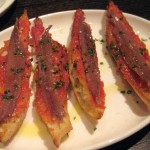 Pan con tomate y anchoas Españoles: toasted slices of rustic bread brushed with fresh tomato with Spanish anchovies