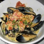 Mussels Dijonnaise: garlic, shallots, tomato confit, house mustard, tarragon and cream