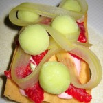 Raspberries atop a waffle with celery cream and sorbet