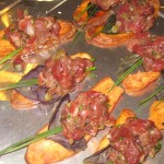 Filet mignon tartare served on a crispy fingerling chip with fresh thyme