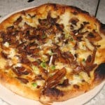 Almond cap mushroom pizza with spring garlic and Tallegio