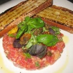 Tuna tartare with mustard, oven-roasted tomato and crostini