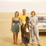 The Gayot family with a Touareg kid and Peugeot 505 in the Sahara Desert in 1981