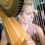 A harpist provides pleasant background music during afternoon tea