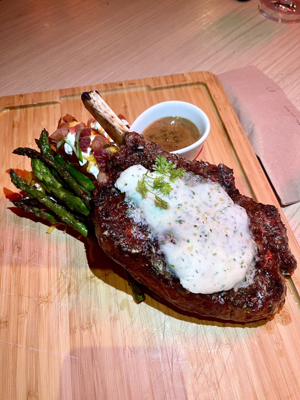 20 oz. bone-In ribeye steak, crispy mashed potatoes, asparagus, peppercorn sauce