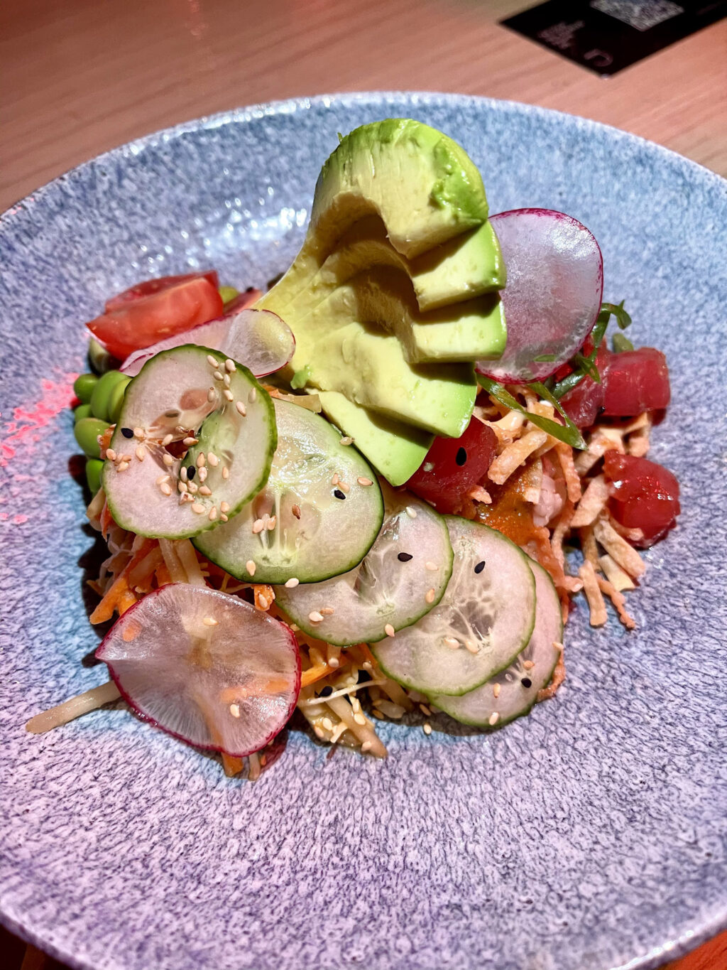 Tuna poke bowl, sashimi grade ahi tuna poke, crispy wontons, green papaya slaw, miso dressing, brown rice